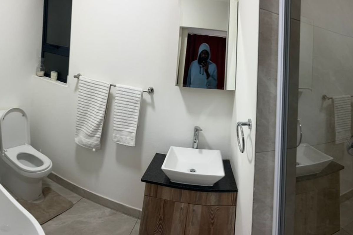 Modern bathroom featuring a freestanding bathtub, vessel sink vanity, and a separate shower enclosure with neutral tile finishes.