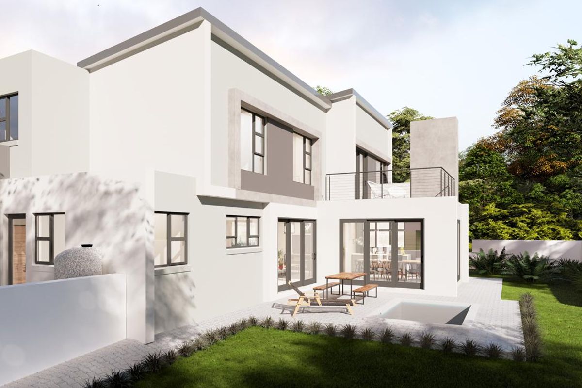 Rear view of a modern two-story house featuring a paved patio, a small plunge pool, and an upper-level balcony with metal railings.