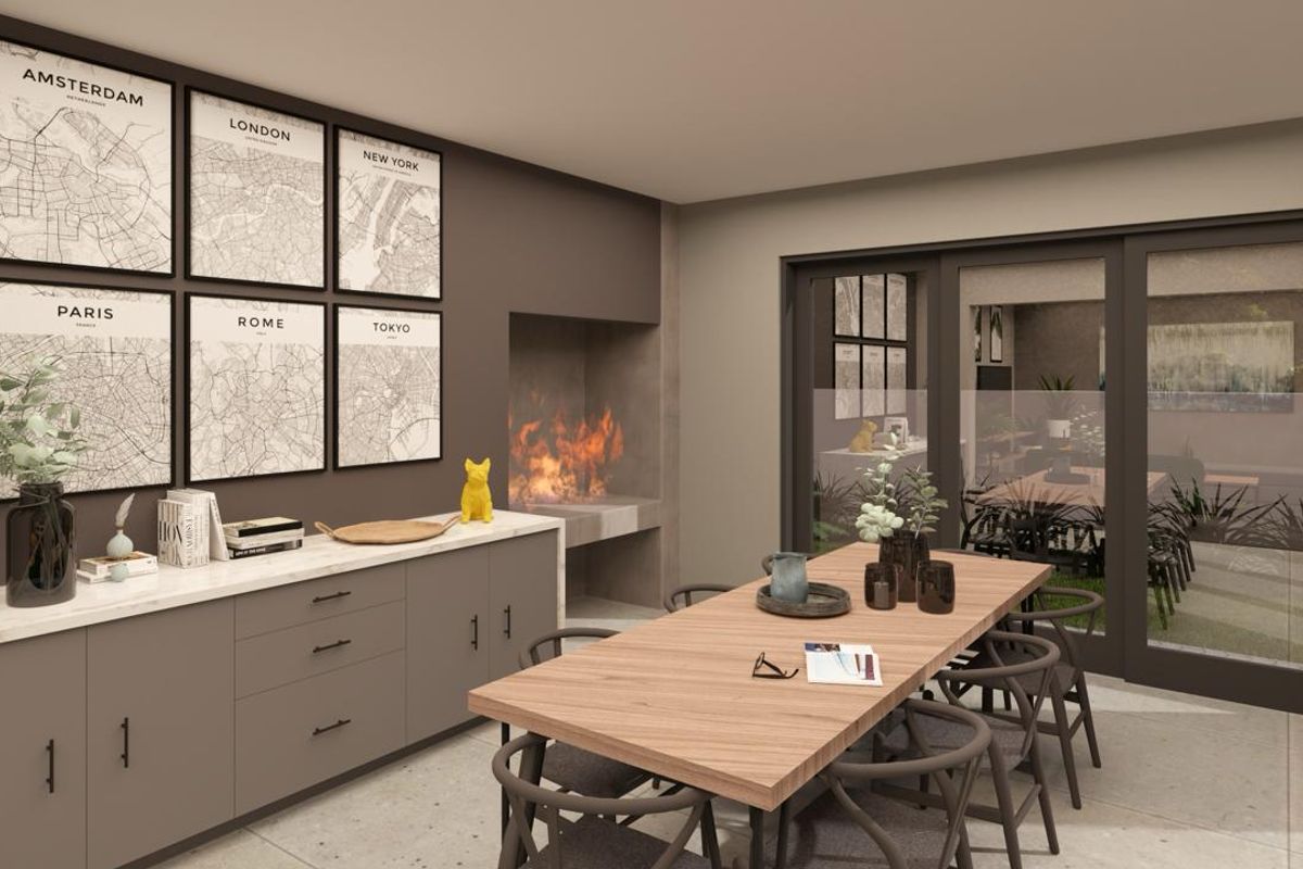 Modern dining area featuring built-in cabinetry with stone countertops, a contemporary fireplace, and large sliding glass doors providing access to the outdoor space.