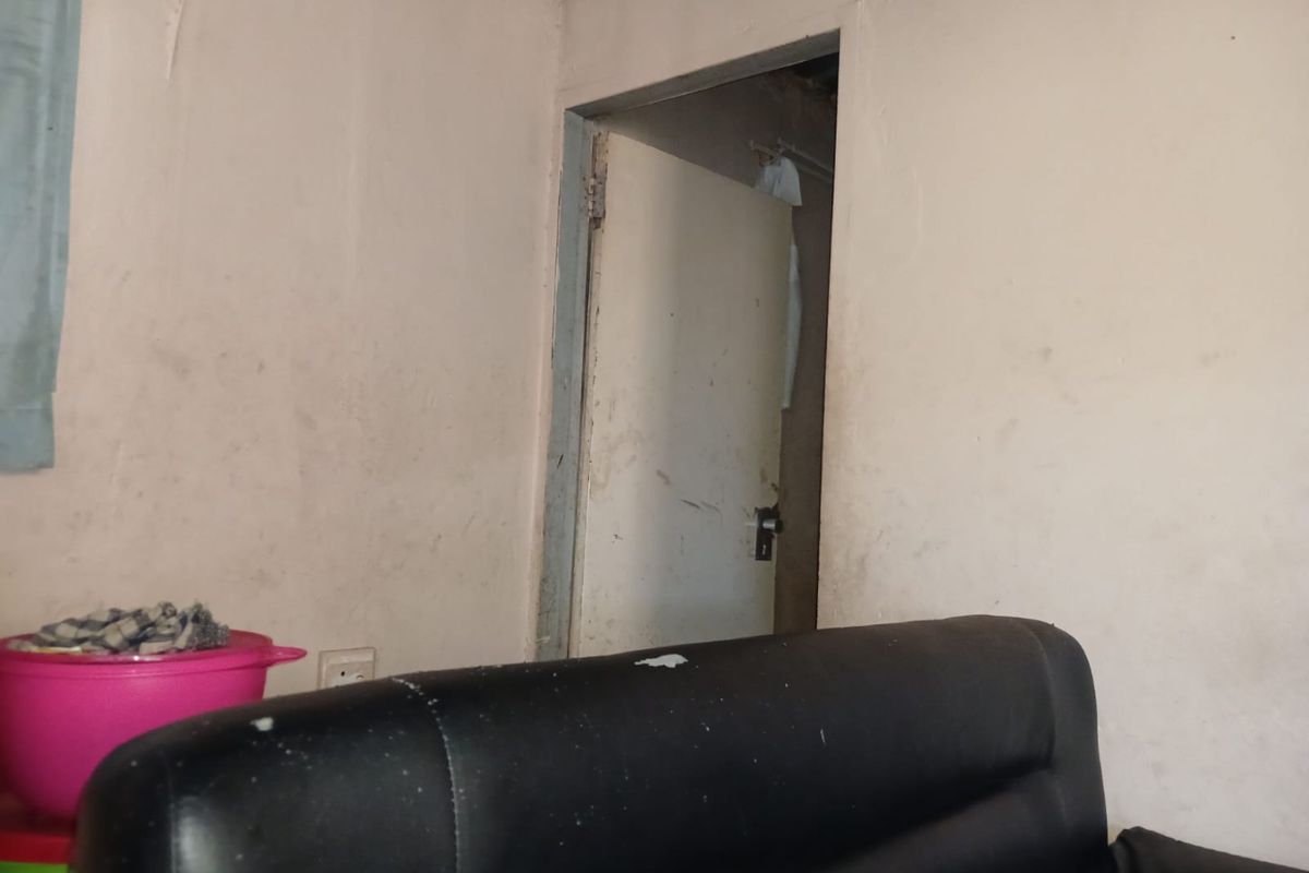 A bedroom interior showing significant wall staining and wear, requiring cosmetic updates and maintenance to improve the overall condition of the space.