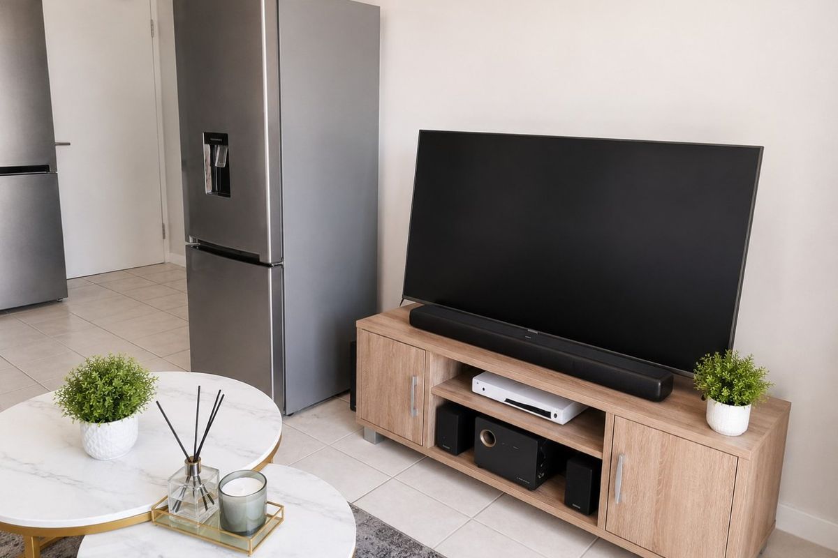 A bright living area featuring neutral tiled flooring and a clean, modern layout suitable for comfortable daily living.