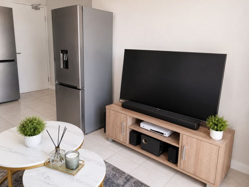 A bright living area featuring neutral tiled flooring and a clean, modern layout suitable for comfortable daily living.
