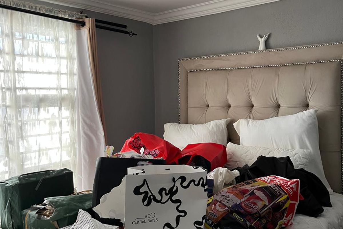 A bedroom featuring crown molding, recessed lighting, and a flush mount ceiling fixture. The space is currently cluttered with personal items.