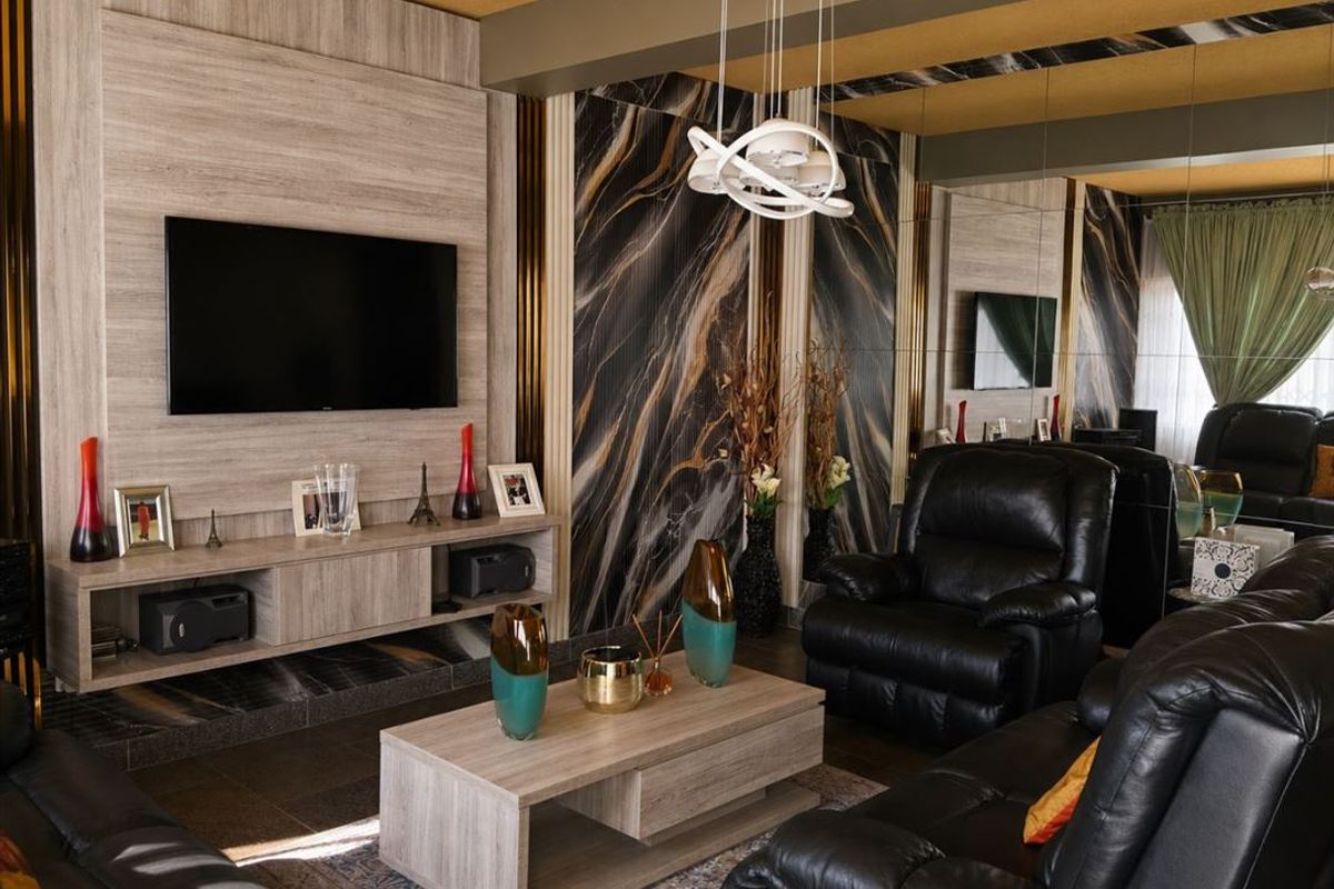 Modern living room featuring a custom media wall, marble-effect feature paneling, mirrored wall accents, and contemporary recessed ceiling lighting.