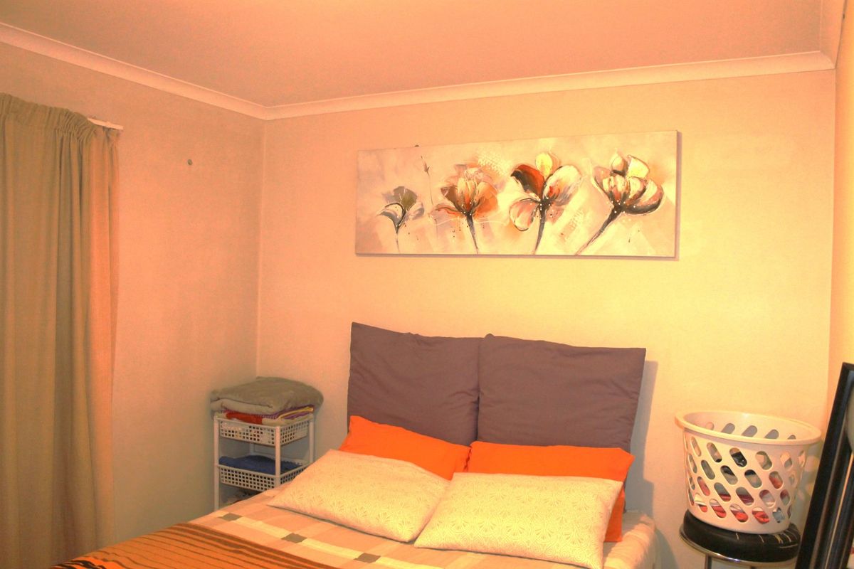 A standard bedroom featuring neutral wall finishes and cove cornicing, providing a functional space for rest.