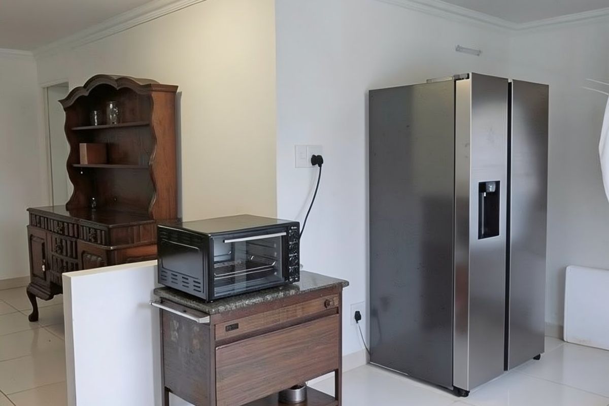 A functional kitchen area featuring tiled flooring, neutral walls, and a low-profile ceiling light fixture.