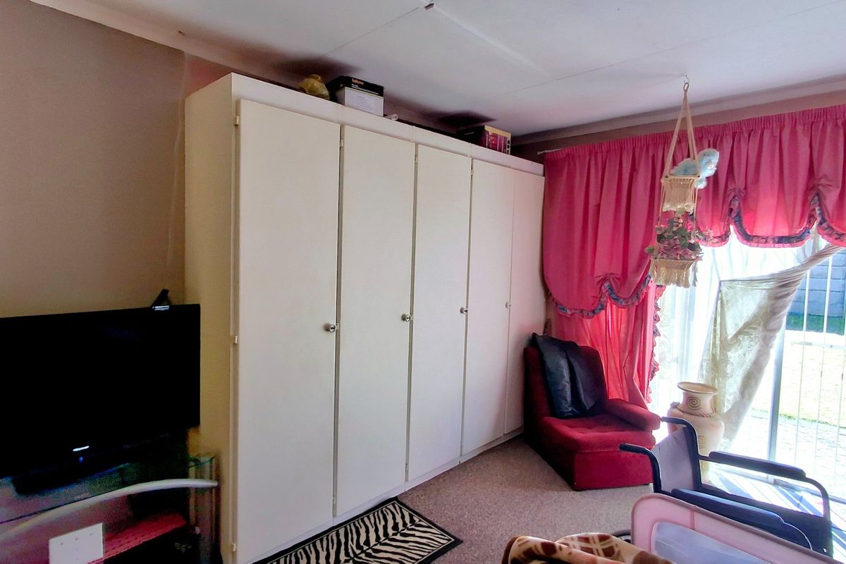 Bedroom featuring a large built-in wardrobe and sliding glass door access to the exterior.