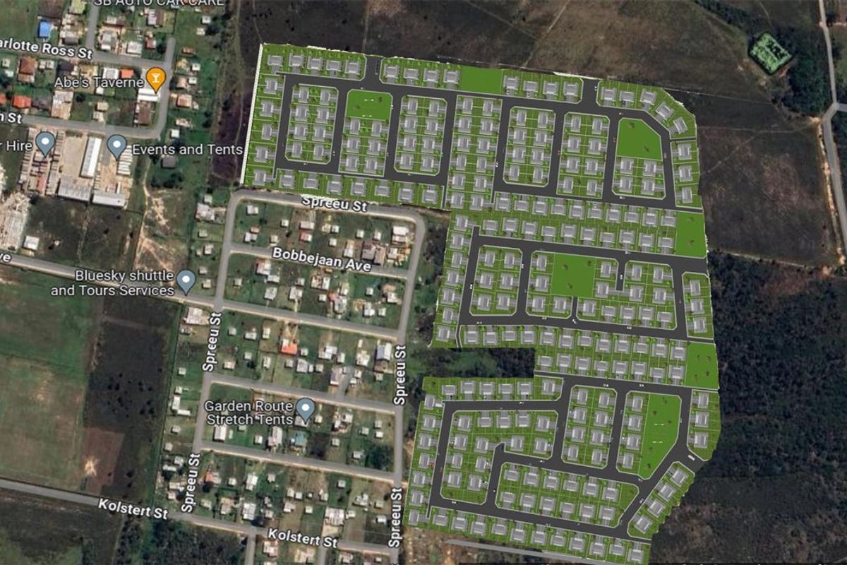 An aerial view showing the layout of a residential development project with planned road networks and housing plots.