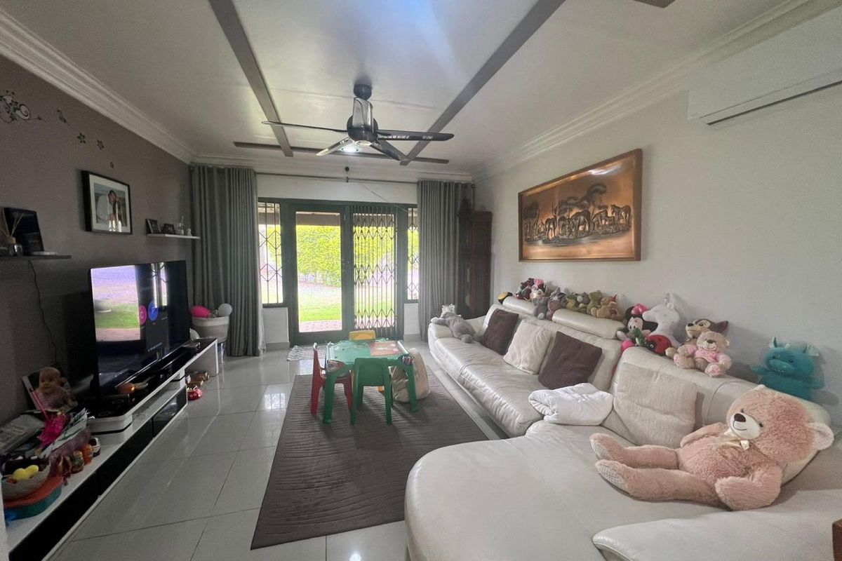Spacious living room featuring tiled floors, a ceiling fan, split-system air conditioning, and direct access to the outdoor area through a sliding glass door.