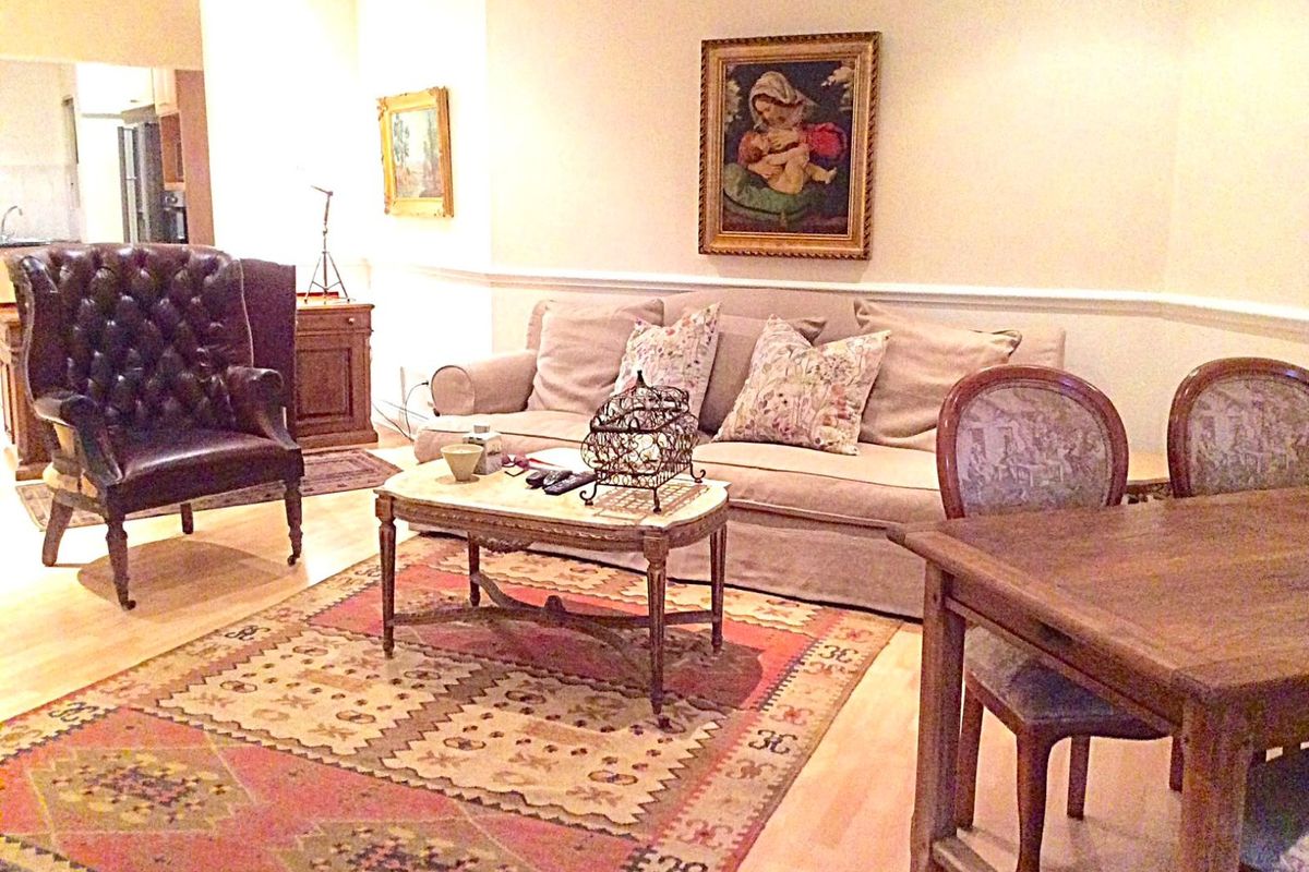Open plan living and dining area featuring hardwood flooring and classic chair rail molding, providing a versatile space for relaxation and meals.