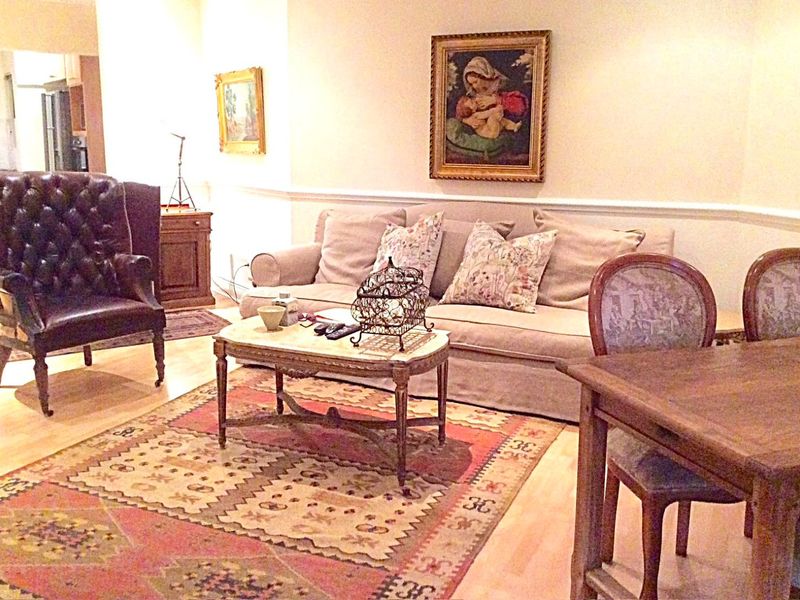 Open plan living and dining area featuring hardwood flooring and classic chair rail molding, providing a versatile space for relaxation and meals.