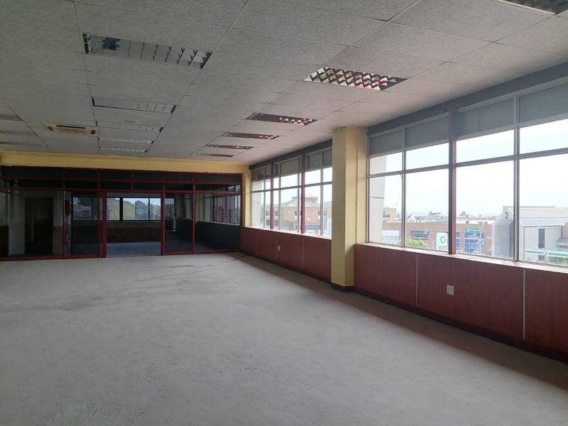 Spacious, vacant commercial office area featuring large windows with natural light, suspended ceilings, and internal glass partitioning, ready for custom fit-out.