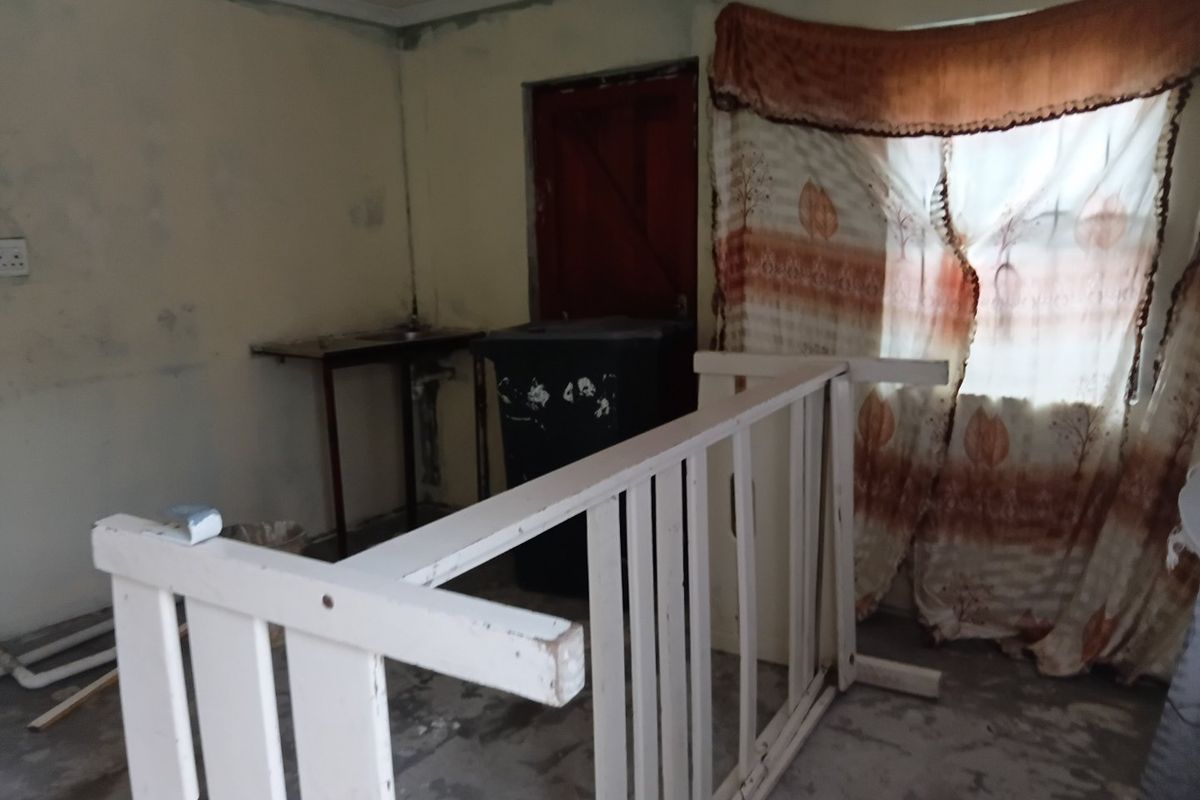 An interior room in need of renovation, featuring unfinished walls and flooring, suitable for a complete cosmetic update.