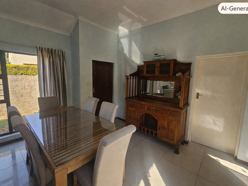 A dining room featuring tiled flooring, a vaulted ceiling, and a sliding glass door providing access to the exterior.
