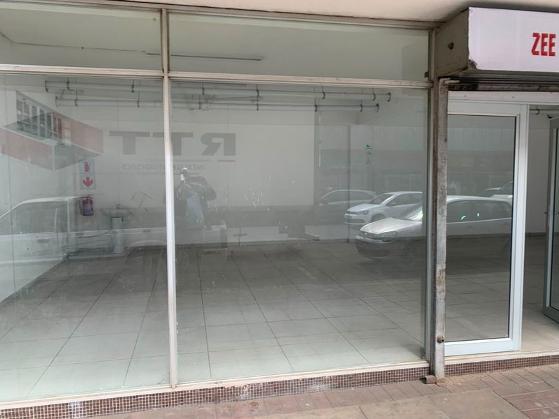 Commercial storefront featuring a large glass display window, tiled flooring, and a pedestrian entrance, suitable for retail or office use.