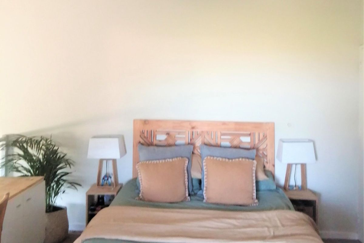 A bedroom featuring a neutral wall finish and carpeted flooring.