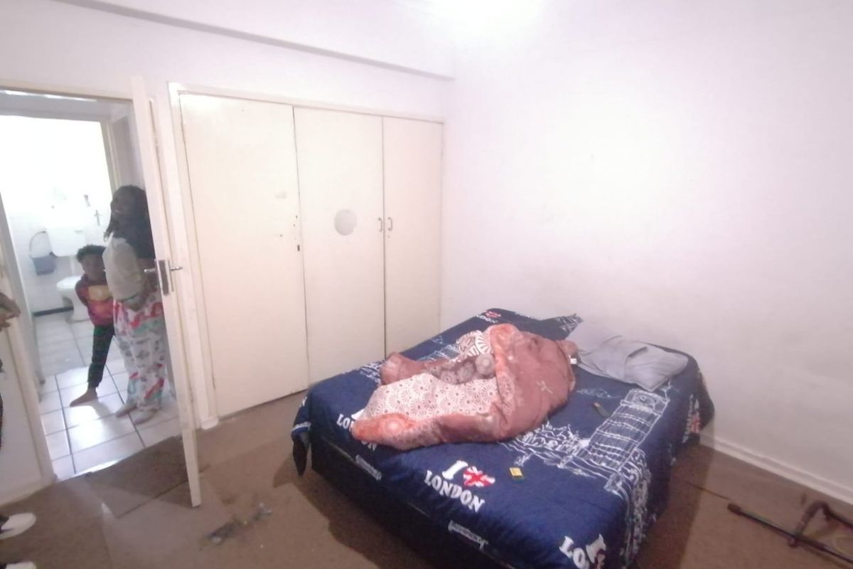 A bedroom featuring built-in cupboards and carpeted flooring, requiring cosmetic updates to improve its overall condition and appeal.