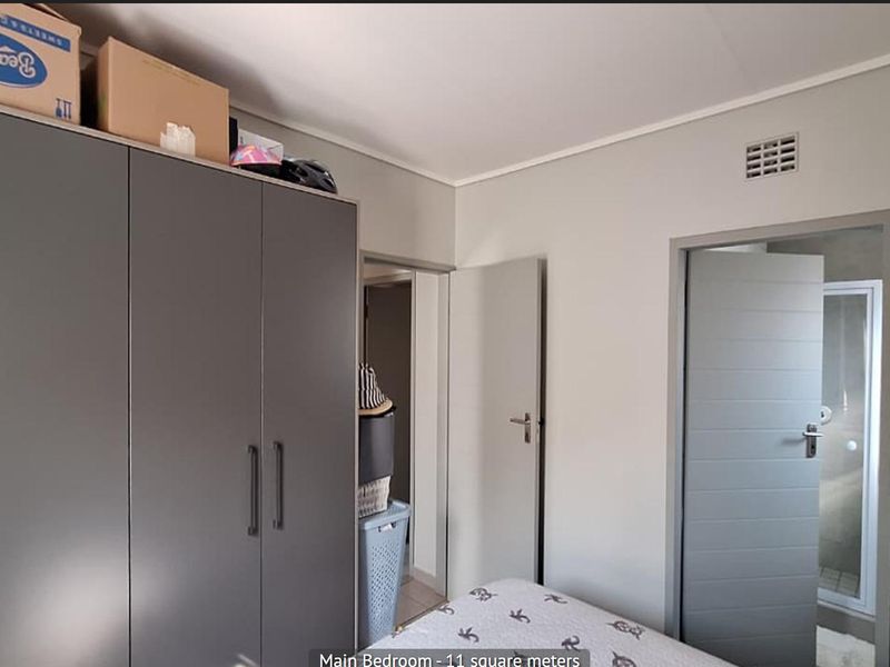 A bedroom featuring a built-in wardrobe and direct access to an adjoining bathroom.