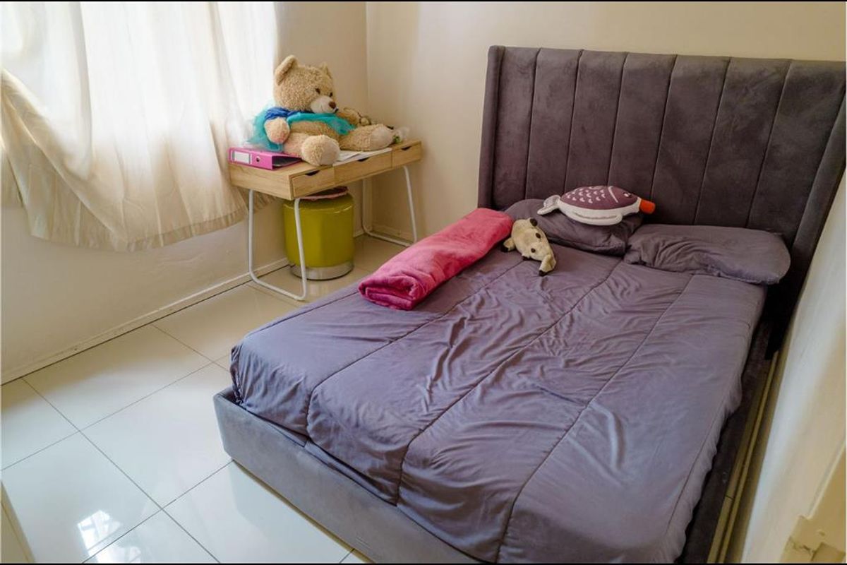 A bedroom featuring tiled flooring and neutral wall finishes, providing a functional space for rest.