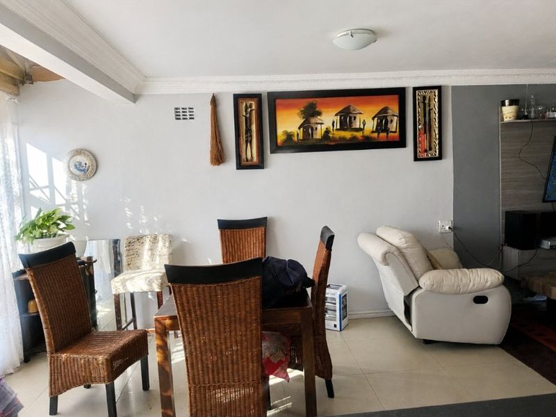 Open plan living and dining area featuring tiled flooring and neutral wall finishes, providing a versatile space for daily living and entertaining.