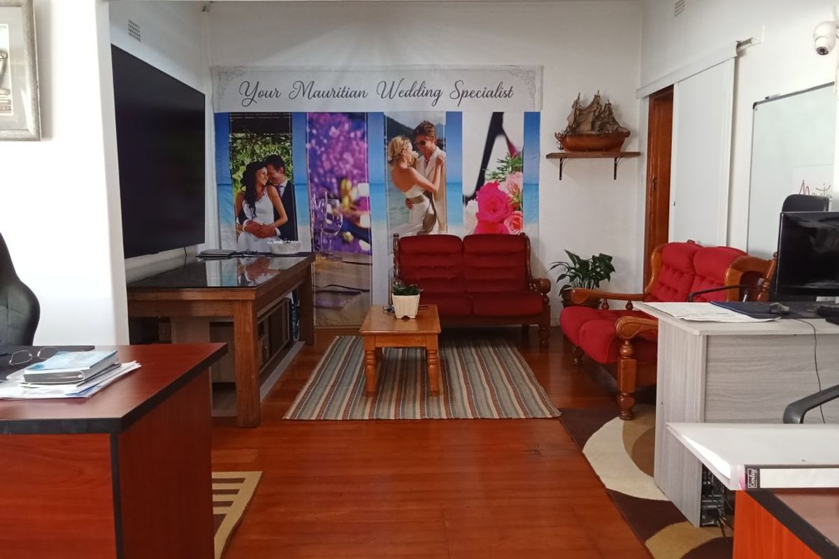 A living area featuring hardwood flooring and a sliding door, currently utilized as a commercial office space.