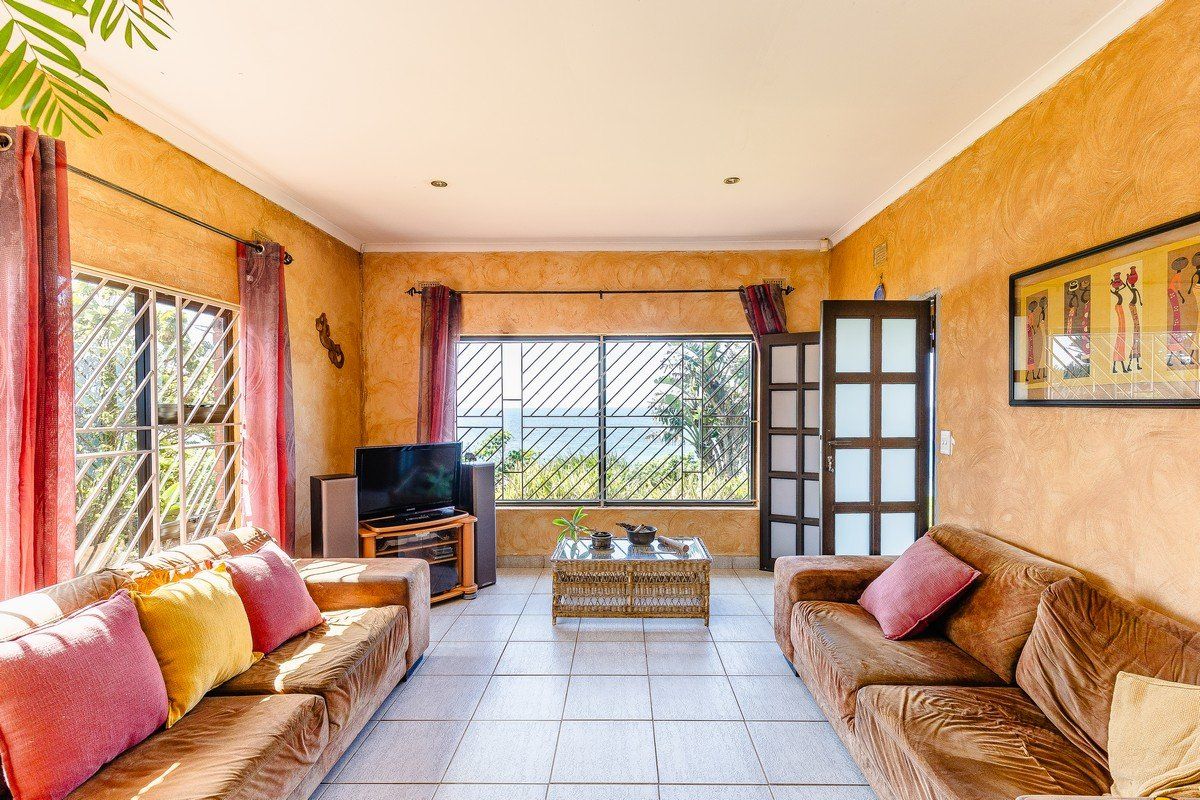 A living room featuring tiled flooring, security bars on windows, and a french door, offering a functional space with natural light.
