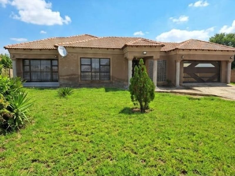 Front elevation of a single-story house featuring a tiled roof, integrated garage, and security bars on windows, set behind a front lawn.