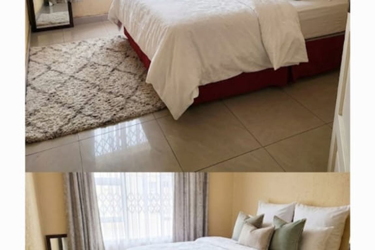 A bedroom featuring tiled flooring and a window fitted with a security gate.