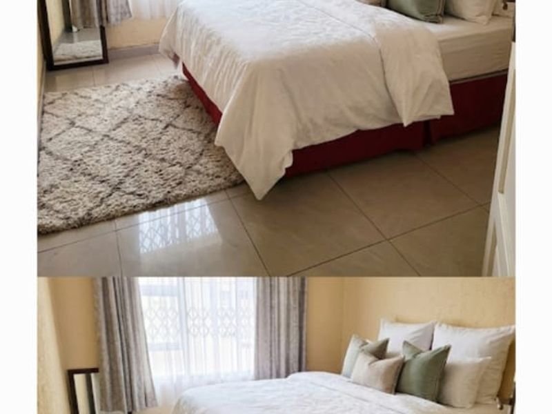 A bedroom featuring tiled flooring and a window fitted with a security gate.