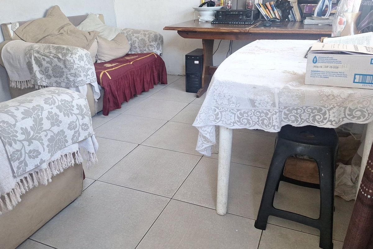 A living area featuring neutral ceramic floor tiles, providing a functional base for the space.