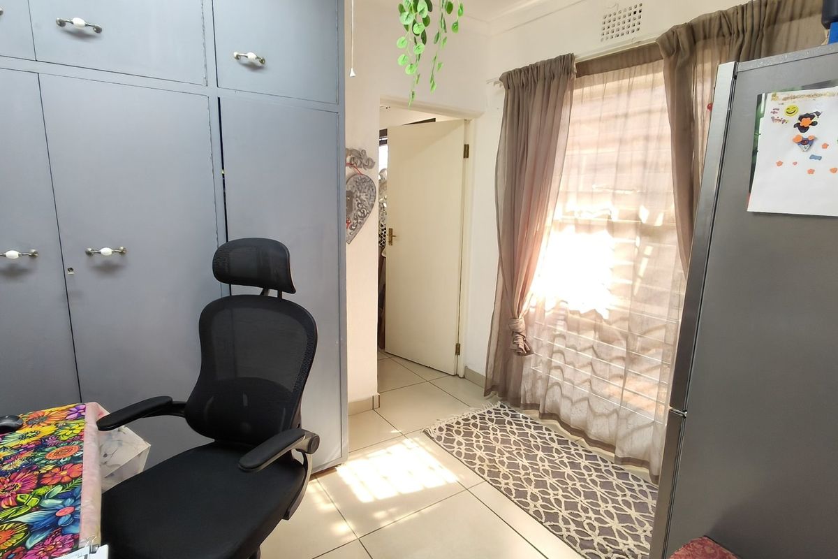 A bedroom featuring built-in cupboards and tiled flooring, providing functional storage and a neutral base for interior design.