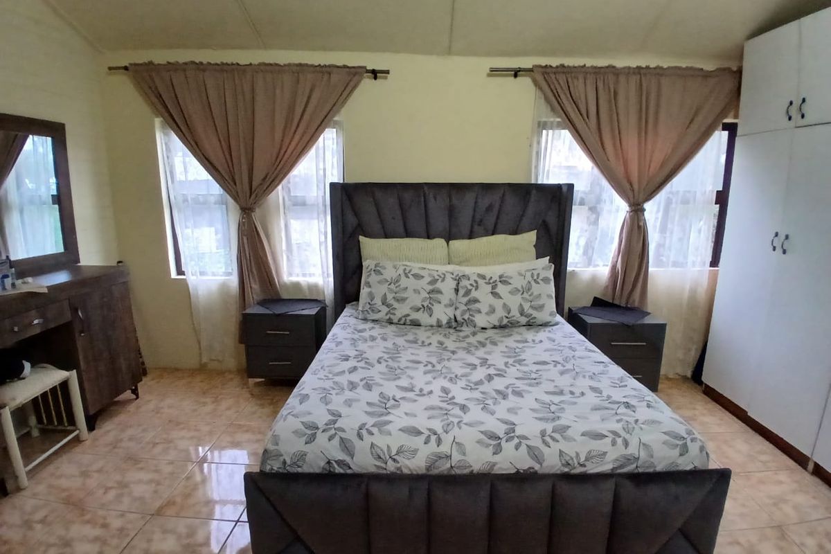 A bedroom featuring tiled flooring and a built-in wardrobe, providing functional storage space.