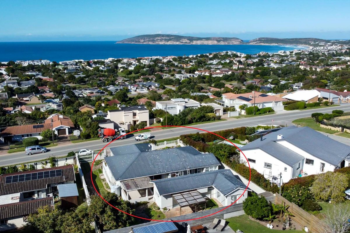 Aerial view of the property highlighting the roof structure and surrounding coastal neighborhood context.