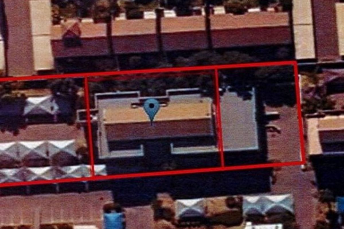 An aerial satellite view showing the property footprint and surrounding commercial site layout.