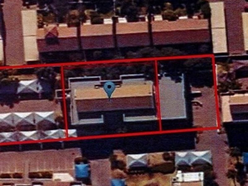 An aerial satellite view showing the property footprint and surrounding commercial site layout.