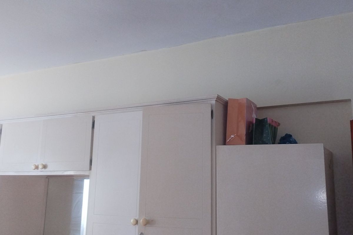A bedroom featuring built-in cabinetry with white doors, providing ample storage space.