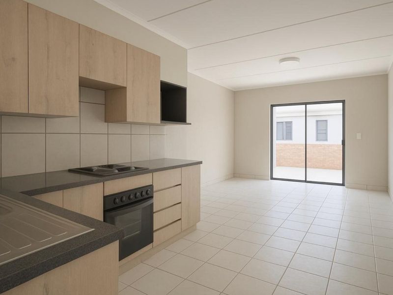 Modern open-plan kitchen and living area featuring light wood cabinetry, built-in oven, tiled flooring, and direct access to an outdoor patio area.