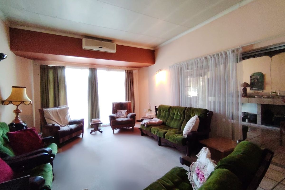 Spacious living room featuring a split-system air conditioner and large sliding glass doors providing natural light.