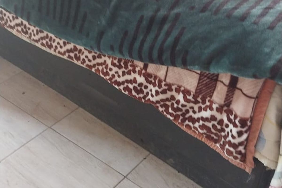 A bedroom interior featuring tiled flooring.