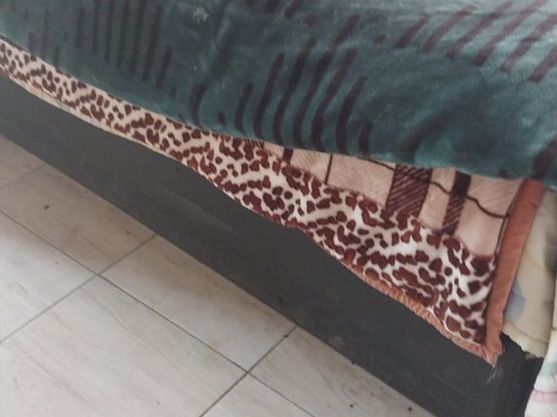 A bedroom interior featuring tiled flooring.