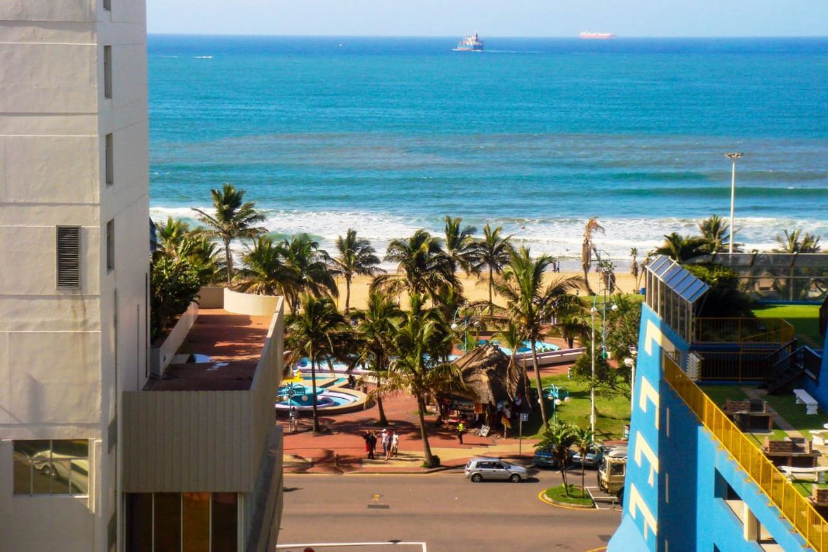 Elevated view overlooking the coastal road, beach, and ocean, capturing the surrounding seaside environment and local landscape.