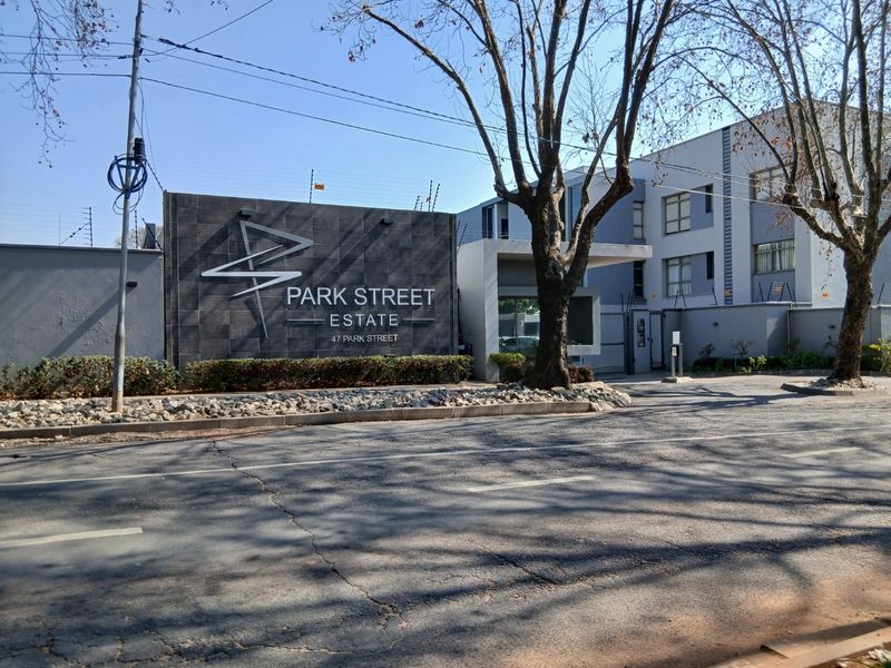 Street view of the Park Street Estate entrance, featuring modern stone signage, secure perimeter fencing, and a gated access point.
