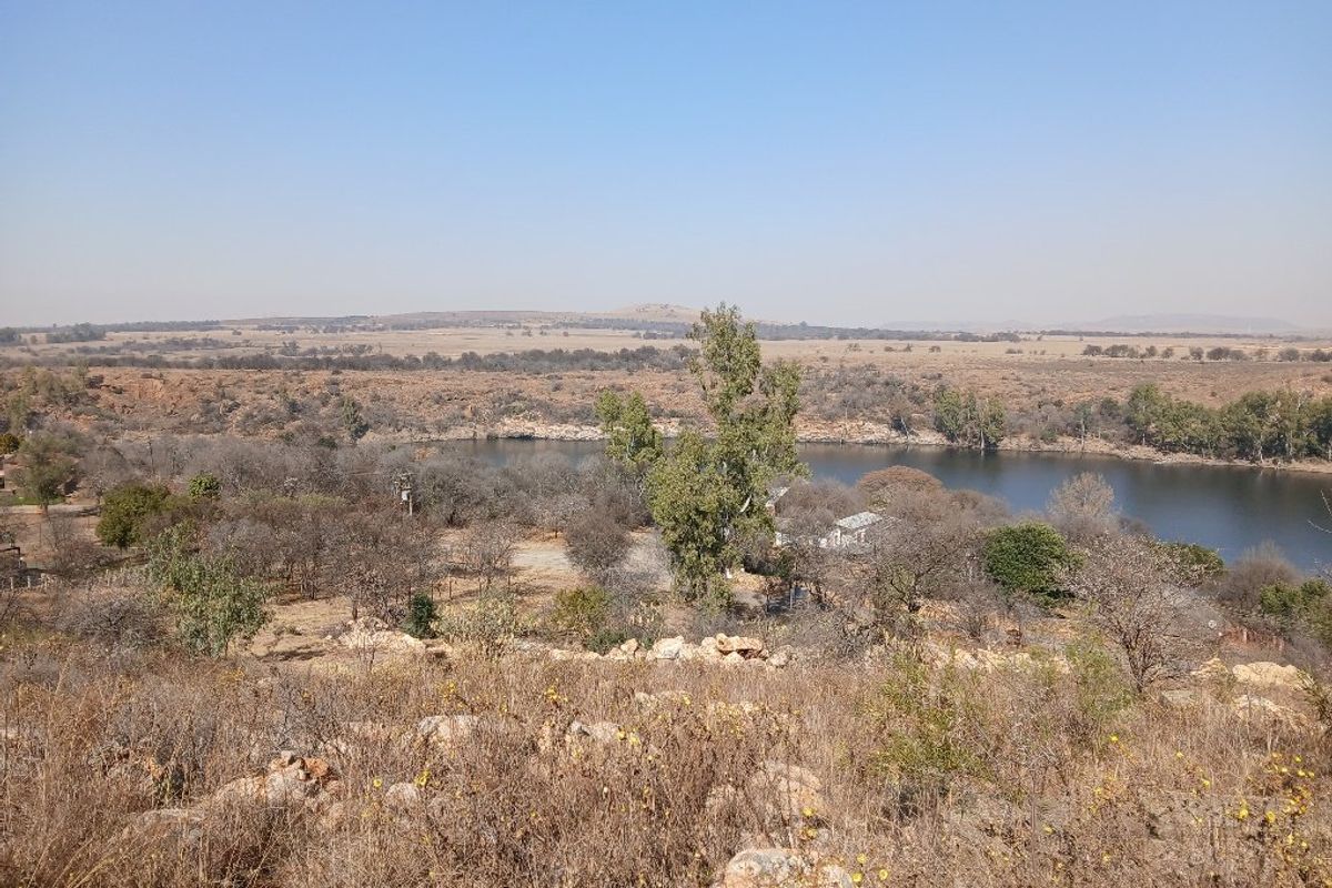 A scenic elevated view of the natural landscape featuring a river and surrounding vegetation on the vacant residential land.