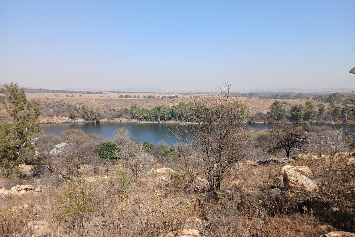 A scenic view overlooking a river and natural landscape, showcasing the property's surrounding environment and topography.