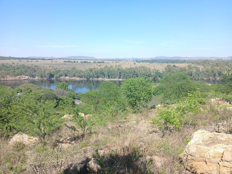 A scenic elevated view overlooking a river and natural landscape, showcasing the property's tranquil surroundings and natural terrain.