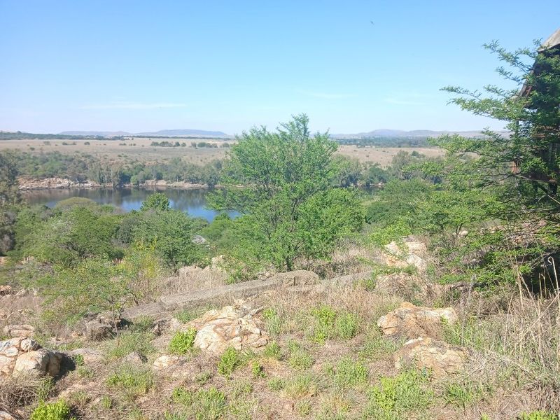 A scenic elevated view overlooking a river and natural landscape, showcasing the property's tranquil surroundings and topography.