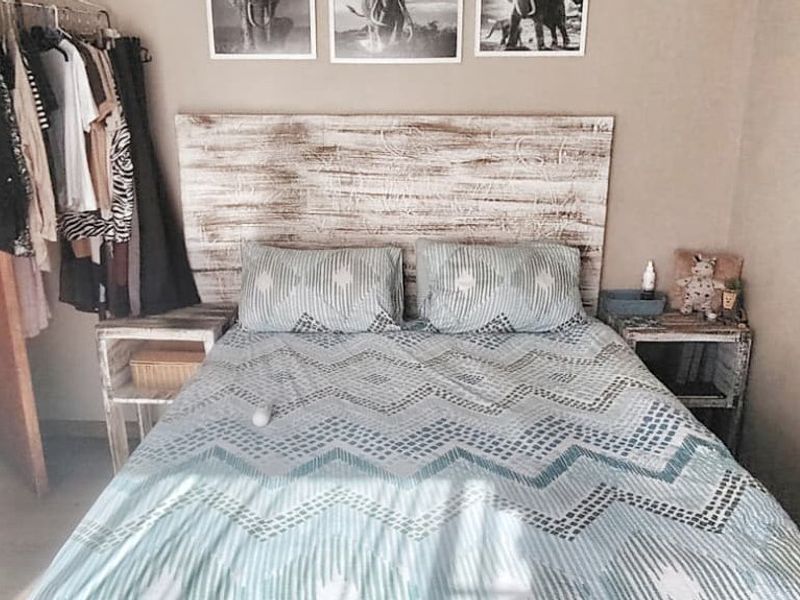 A cozy bedroom featuring laminate flooring and a neutral wall finish, providing a comfortable and functional sleeping space.