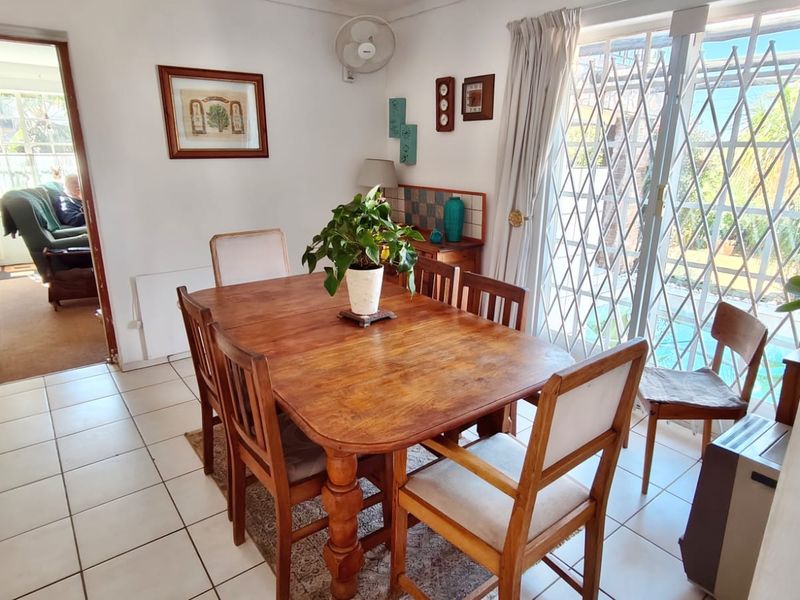 Dining room featuring tiled flooring and a sliding glass door with a security gate, providing direct access to the outdoor area.