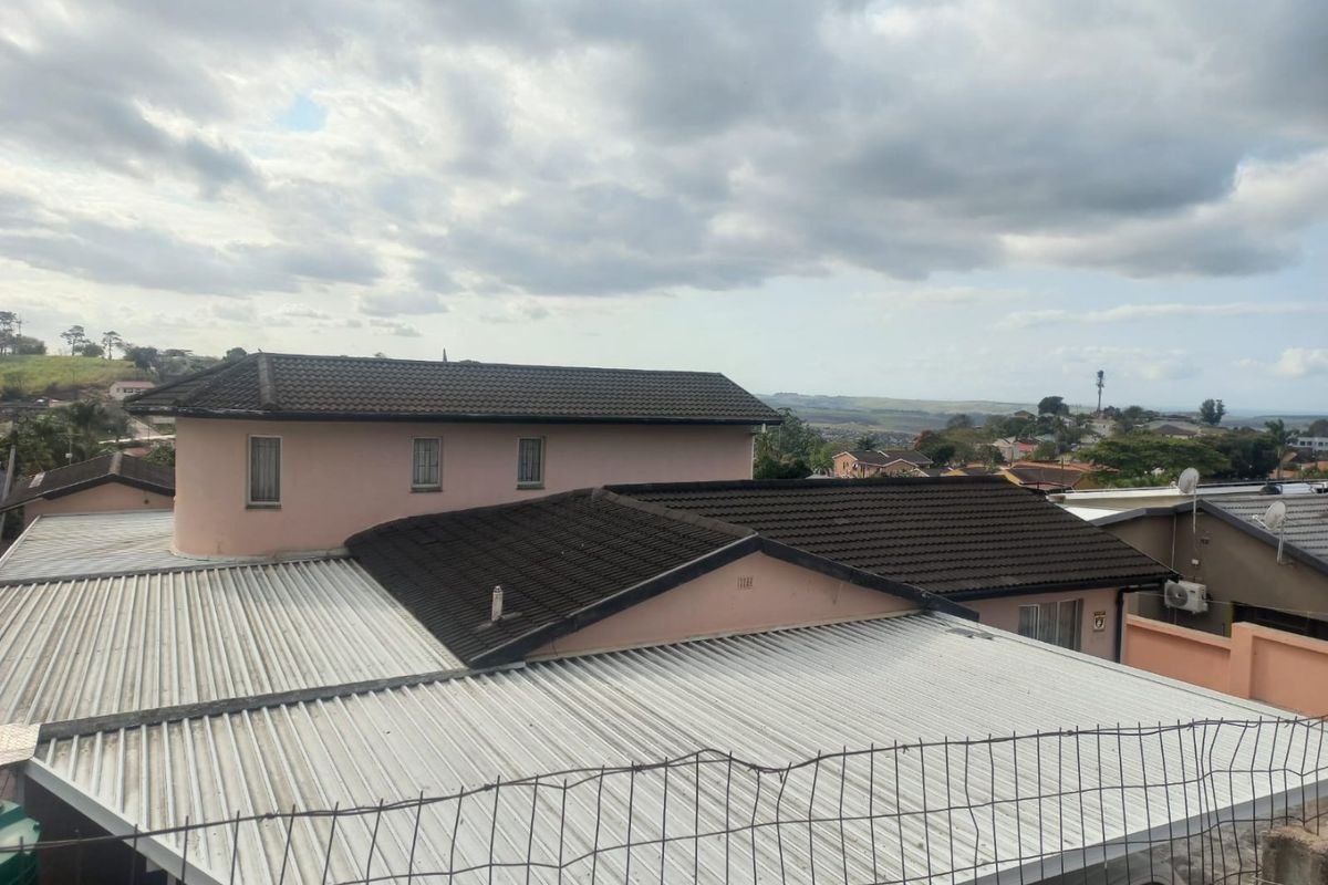 An elevated view showing the roof structures of the property and surrounding residential neighborhood.