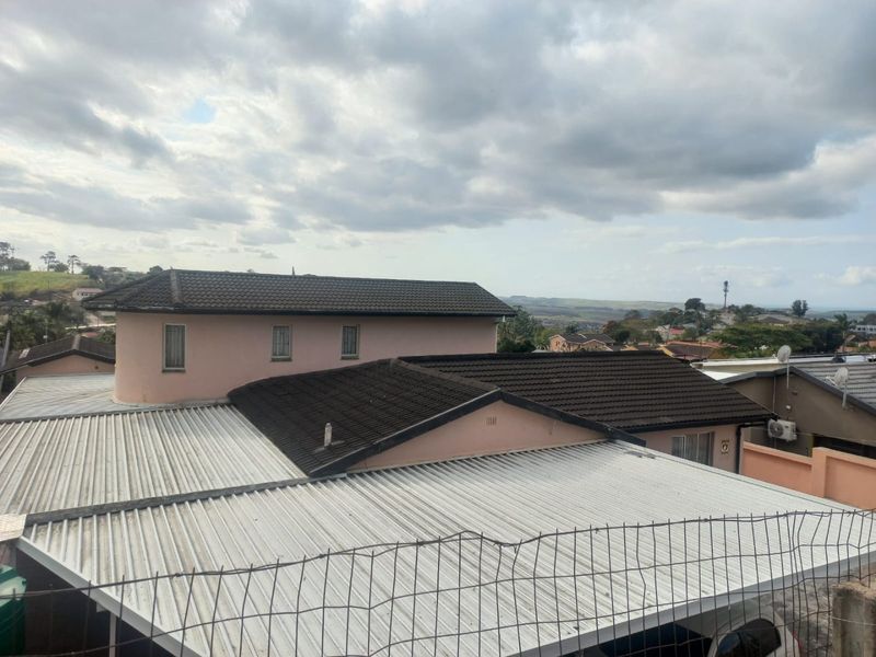 An elevated view showing the roof structures of the property and surrounding residential neighborhood.